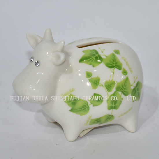Keramische kleine Kuh mit grünen Abziehbildern Sparschwein